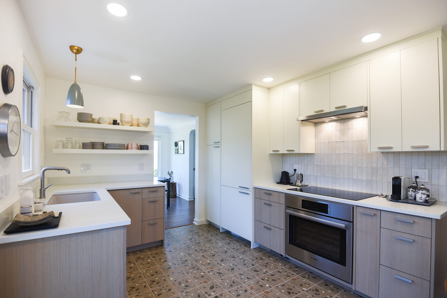 A pale wood and white West Seattle kitchen with a long island